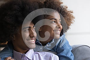 Closeup faces of beautiful African teenagers couple look into distance