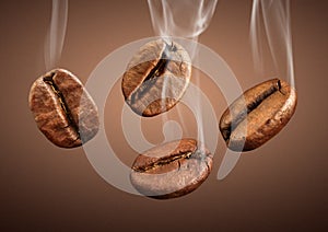 Closeup falling coffee beans with smoke on brown background