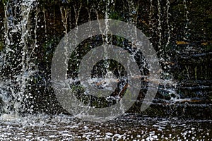 Closeup of falling and splashing streams of water, Ivande waterfall, Latvia