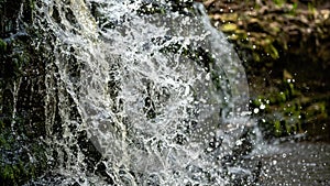 Closeup of falling and splashing streams of water, Ivande waterfall, Latvia