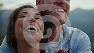 Closeup family faces laughing outdoor. Happy couple having fun in mountains.