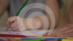 Closeup of family hands drawing colorful pictures, enjoying weekend together