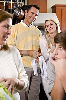 Closeup family in kitchen looking at each other