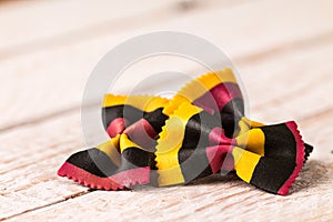 Closeup of Farfalle pasta on white wooden background