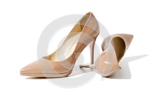 Closeup fashion high heels women shoes beige color  on white background. Top view. Stiletto shoe style in ladies wardrobe