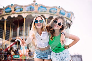 Closeup fashion lifestyle portrait of two pretty best friends girls, wearing bright swag style floral hats, mirrored sunglasses, h