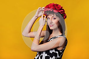 Closeup fashion portrait of beautiful model woman with bright makeup. Beauty face. Isolated on orange or yellow colorful