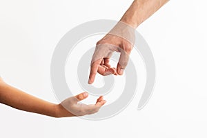 Closeup of father and daughter reaching hands