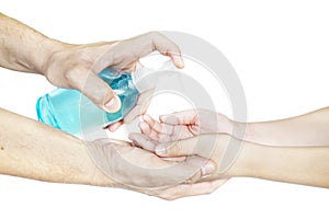 Closeup of father hand pushing alcohol sanitizer gel pump dispenser to son hand isolated over white background