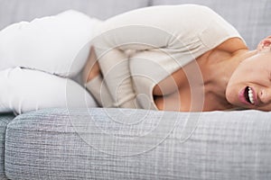 Closeup on feeling bad young woman laying on sofa