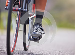 Closeup of the feet of one young woman exercising outside in the forest. Healthy and sporty female athlete with her feet