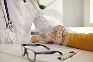 Closeup female doctor hold male patient hand give medical help support reassure