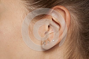Female ear with earrings