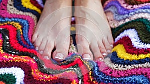 Closeup of a female feet with white french pedicure on nails