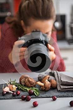 Closeup on female food photographer taking photo