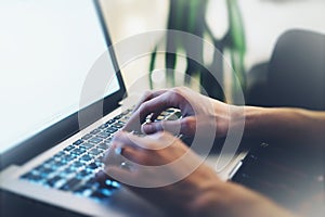 Closeup female freelancer sitting front open laptop computer with blank screen blue monitor, young business woman work on notebook