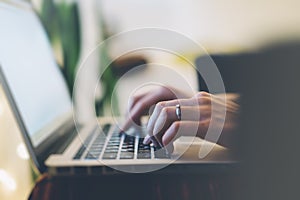 Closeup female freelancer sitting front open laptop computer with blank screen blue monitor, young business woman work on notebook