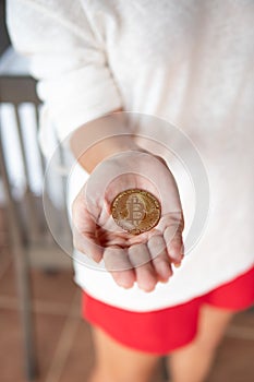 Closeup female hand with bitcoin
