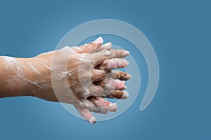 Closeup of female hand hygiene with soap and interlaced fingers
