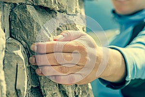 Closeup of female hand rock climbing.