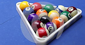 Closeup of female hand twists billiard ball 13 on billiard table