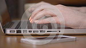 Closeup of a female hands busy typing on a laptop.