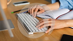 Closeup Of Female Hands On Computer Keyboard Typing At Workplace