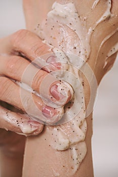 Closeup of female hands covered in natural scrub, body care concept