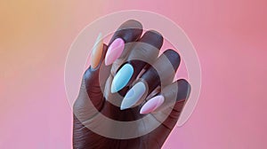 closeup of female hands with delicately painted nails against a pastel backdrop