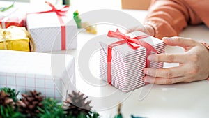Closeup female hands holding gift box
