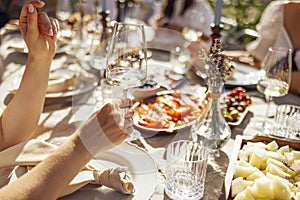 Closeup of female hands holding glasses of champagne. Making a celebratory toast with sparkling wine