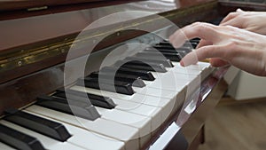 Closeup. female hands masterfully play the arpeggio on the piano