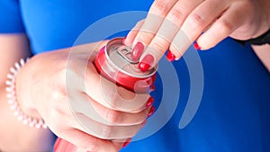 Closeup of female hands opening can of drink