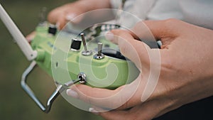 Closeup female hands remote control sticks of control of FPV racing drone