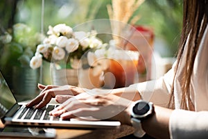 Closeup female hands typing on laptop keyboard. Woman working at home office concept