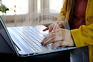 Closeup female hands typing text on computer keyboard, businesswoman at workplace, concept of remote work, modern technology,