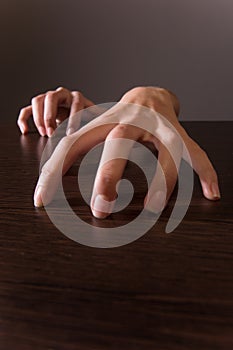 Closeup on female hands on wooden table