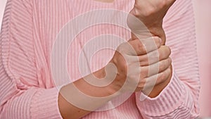 Closeup of female holding her painful wrist caused by prolonged work on the computer or housewife, Carpal tunnel syndrome, arthrit