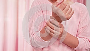 Closeup of female holding her painful wrist caused by prolonged work on the computer or housewife, Carpal tunnel syndrome, arthrit