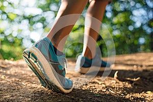 Closeup of female legs wearing runnning shoes in the nature