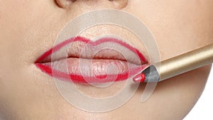 Closeup female red lips with makeup contour lip liner