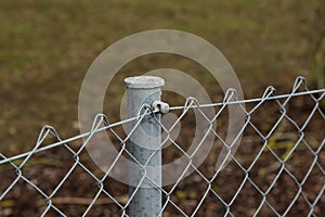 Closeup of a fence made of metal posts and metal mesh