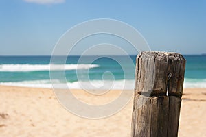 Closeup of fence post at surfing beach on sunny summers day