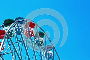 Closeup of a ferris wheel with blue sky