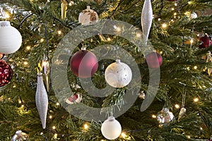 Closeup festive decorated Christmas tree balls lights