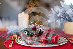 Closeup of festive holiday place setting with bokeh lights in background