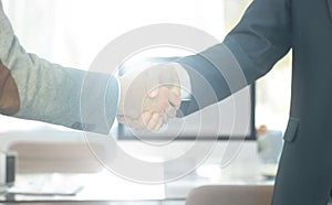 Closeup .the financial partners shaking hands over a Desk