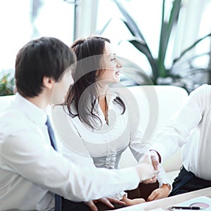 Closeup.the financial partners shaking hands over Desk