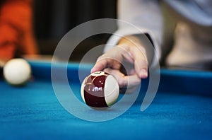 Closeup of finger on billard ball