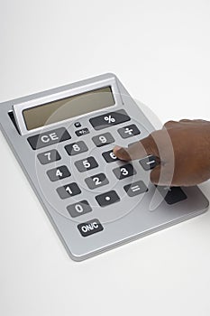 Closeup Of Finger Pressing Key On Digital Calculator